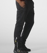 Designed for high-level comfort and superior performance, an athletic track pant is crafted in sleek stretch microfiber with hydro-mesh panels and reflective graphics.