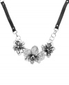 Nature's inspiration. Fossil's bold and beautiful necklace features three carefully-detailed orchids with clear crystal accents and openwork detailing. Set in silver tone mixed metal and strong on a chocolate leather chain. Features a lobster claw closure. Approximate length: 18 inches + 2-inch extender.