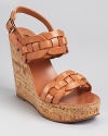 Interwoven leather forms luxe links on the Tory Burch Calyca sandals, finished with a cork sole--giving the usual summer-shoe staples a run for their money.