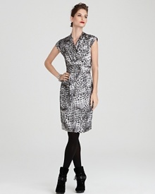 A bold snake print lends exotic flair to this Jones New York Collection dress, designed in an ultra-flattering faux wrap silhouette. Toughen it up with slouchy boots for downtown cocktails.