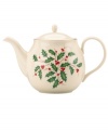 Perfect for entertaining, this porcelain teapot is trimmed with gold and a holly motif to match the beloved Lenox Holiday dinnerware collection.