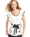 Grand ruffles and dark, contrasting trims make this BCX top a cute and whimsical closet essential.