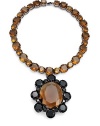 THE LOOKA dramatic look in two tones of bold faceted glassNecklace of brown, round faceted glass stonesFlower pendant with brown center framed by black petalsGunmetal prong settingFoldover claspTHE FITLength, about 17Pendant, about 3¼L X 2¾WTHE MATERIALGlassGunmetal platingORIGINImported