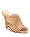 Slim leather straps arch over these high-heeled sandals. Wear to toughen up a sweet sundress--or try with cuffed denim.