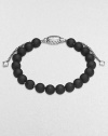 From the Spiritual Bead Collection. Rich black onyx beads are accented by polished sterling silver.Black onyx Sterling silver Width, about 8mm Diameter, about 2 Adjustable clasp Imported