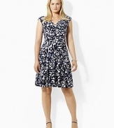 This dress boasts a V-neckline and crossover bodice with slight shirring at the empire waist.