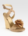 Adjustable, soft leather straps and an artful flower adornment add ladylike vibes to this timeless straw wedge. Straw wedge, 4 (100mm)Covered platform, ½ (15mm)Compares to a 3½ heel (90mm)Suede and straw upperLeather lining and solePadded insoleMade in SpainOUR FIT MODEL RECOMMENDS ordering true size. 