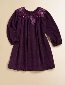 An ultra-soft, rich-colored knit with a smocked neckline and delicate flowers. ScoopneckSmocked necklineLong sleeves with elastic cuffsA-lineButton back92% polyester/8% spandexHand wash or dry cleanImported