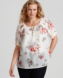 A delicate floral-print adorns this Karen Kane blouse for a soft, feminine touch.