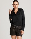 In mysterious black, this chic Vince blouse softens the look of crisp denim with a soft rounded hem and femme back pleats. Made of luxe stretch silk, the silhouette holds its shape beautifully, making it a worthy investment piece.