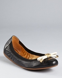 A leather bow lends a playful feel to a pair of classic black flats from Kate Spade.