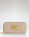 MARC BY MARC JACOBS' zip around leather wallet is a practical accessory with a playful side. In a punched up hue, this wallet is almost too chic to hide in your purse.