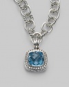 A sparkling faceted blue topaz, surrounded by pavé diamonds, sits in a squared setting of sterling silver with a cabled edge and fluted bale. Blue topaz Diamonds, 0.45 tcw Sterling silver with a black rhodium finish About ¾ square Spring clip clasp Made in USA Please note: Necklace sold separately.