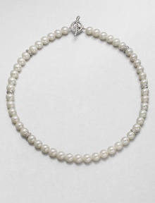 From the Pearl Crossover Collection. A lustrous strand of freshwater pearls accented with sterling silver crossover separators in a long, elegant design. 8mm-8.5mm round white freshwater pearlsSterling silverLength, about 36Toggle closureImported