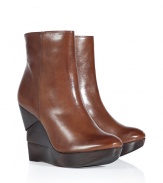 An edgy, sculptural wedge heel informs these ultra-versatile leather wedge booties from Diane von Furstenberg - Round toe, front platform, layered wooden wedge heel, ankle length, side zip closure, shiny leather - Pair with skinny jeans and an oversized pullover or with a printed mini-dress and ribbed tights