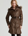 A belted waist lends a flattering silhouette to this down coat by Marc New York, featuring a sumptuous fur-trimmed hood.