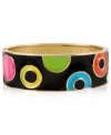 Colorful chic. This bangle bracelet from Betsey Johnson is crafted from gold-tone mixed metal and features vibrant circles and dots on a black background for added appeal. Approximate diameter: 2-1/4 inches.