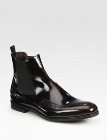 Leather Chelsea boot design with wing-tip detail and side goring.Leather upperLeather liningRubber soleMade in Italy