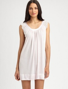 Eyelet cap sleeves with scallop trim make for a truly feminine design, with a wide scoop neckline and front shirring for added drape. Scoopneck with shiny trimEyelet cap sleeves with scallop edgesFront shirringShiny banded hemAbout 34 from shoulder to hem65% polyester/35% rayonMachine washImported