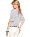 Eyeshadow adds pop to a slouchy-cool top by way of bright, crisscrossed back straps!