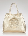 Add a metallic hit to your uptown arsenal with Tory Burch's logo-embossed leather tote. Whether work or weekend, carry this stately style to enliven an all-black palette.