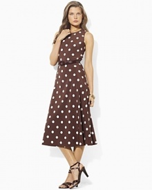 An elegant belted waist and A-line skirt flatter the body in a carefree, flirty silhouette.