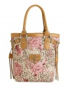 Spice up your handbag collection with this GUESS carryall that's equal parts sweet and sassy. Silvertone logo hardware, trend-right drawstring detail and a floral animal print decorate this stylish bag.