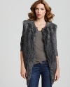 This French Connection faux fur vest boasts warm sweater sleeves, marrying two of the season's chicest trends for a sensational seasonal layering piece.