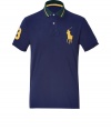 Get your hands on the must-have piece for the upcoming season - This classic polo shirt is designed in fine cotton by Ralph Lauren, the master of American preppy style - Traditional navy, with yellow, embroidered logo on chest and number at sleeve - Slim cut with longer back than front - Pairs well with jeans, chinos or shorts on the weekends or after-hours