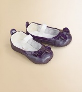 Dainty pearlized patent leather flats for baby with ruffle trim and elastic strap for a comfy, cozy fit.Adjustable elastic strapLeather upperCotton liningLeather soleImported