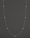 Twelve diamond stations punctuate a long, elegant 18K. white gold chain. By Roberto Coin.