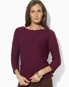 A timeless knit sweater is crafted with a boat neckline and chic three-quarter-length sleeves for an elegant finish.