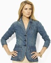 An all-over contrasting topstitch accentuates the finely tailored construction of this sleek denim blazer.