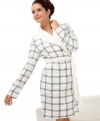 Coziness is calling. Relish the soft fleece and faux shearling trim of the short River robe by Nautica. An understated plaid sweetens the style.