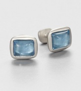 Handsome cabochon cushion cuff links set in sterling silver, highlighted by simulated blue topaz at the center.Sterling silverBlue topazAbout .59 x .67Made in USA