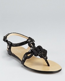 Braided rope, studded hardware and snakeskin details come together on a standout sandal from Calvin Klein.