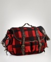 Leather accents and ample pockets lend rugged utilitarian appeal to a messenger bag in buffalo-checked wool.