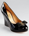 Salvatore Ferragamo showcases classic luxe with the Tosca platforms, a sleek style in patent leather atop a tall wedge.