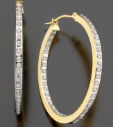 Dazzling diamond accents line these brilliant hoop earrings inside and out. Crafted in 14k gold. Approximate diameter: 1 inch.