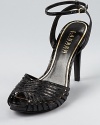 A strappy, snakeskin embossed silhouette from Lauren by Ralph Lauren lends itself to daytime and after-hours alike.