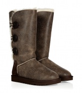 Stylishly distressed and undeniably cozy, these vintage-inspired shearling boots from UGG Australia lend comfort and style to your cold weather look - Round toe, rugged rubber sole, exposed seams, side button detail, contrasting back counter suede panel, cozy shearling lining, weathered finish - Knee height - Pair with skinny jeans, an oversized cashmere sweater, and a down jacket or wool cape