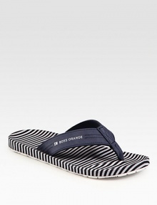 Leather thong sandal with logo detail and striped insole for a sporty feel.Leather upperPadded insoleRubber soleImported