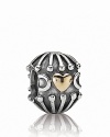 Embrace the combination of oxidized silver and 14K gold with this heart-warming charm from PANDORA.