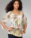 A tunic top with pizazz, from One World. The asymmetrical sleeves and peplum hem give it a unique look!