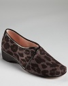 Taryn Rose's Kelsey wedges get a roaring update in leopard print fabric, equipped with a subtle one-inch wedge.