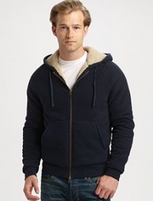 The ultimate in winter warmth and style marries the easy comfort of a cozy, lined cotton knit hoodie.Two-way zip frontAttached drawstring hoodKangaroo pocketsLining: polyesterCottonMachine washImportedAdditional Information Men's Shirts & Sweaters Size Guide 