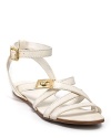 In crisp, summery white with golden accents, Tory Burch's strappy sandals have us longing for vacation. Pair with a beachside cocktail.