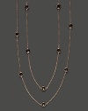 Eighteen bezel set smoky quartz stations sparkle in a long, loopable 14K rose gold chain.