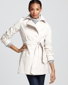 Update your wardrobe with a fresh white coat for a chic spring season. From DKNY.