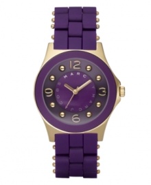 A passion for purple and fashion, by Marc by Marc Jacobs. Watch features purple silicone-wrapped stainless steel bracelet with gold ion-plated accents. Round gold ion-plated case with concave ring. Purple dial features logo, goldtone hands, numerals at twelve, three, six and nine o'clock and gold ion-plated dot markers. Quartz movement. Water resistant to 30 meters. Two-year limited warranty.